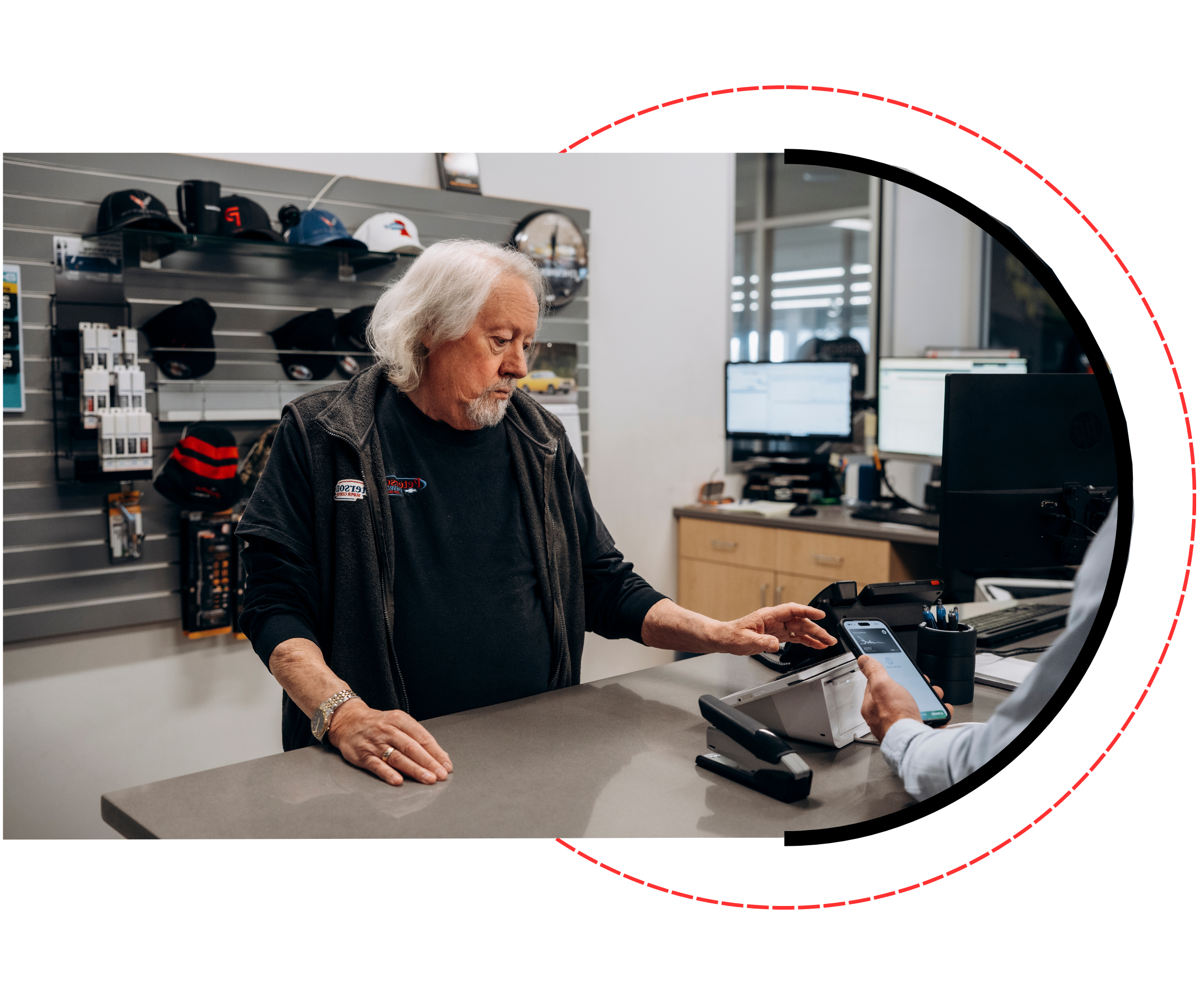 Dealership employee processing a customer payment at the counter, illustrating a pricing option where the dealership covers all credit card processing fees for a seamless checkout experience.