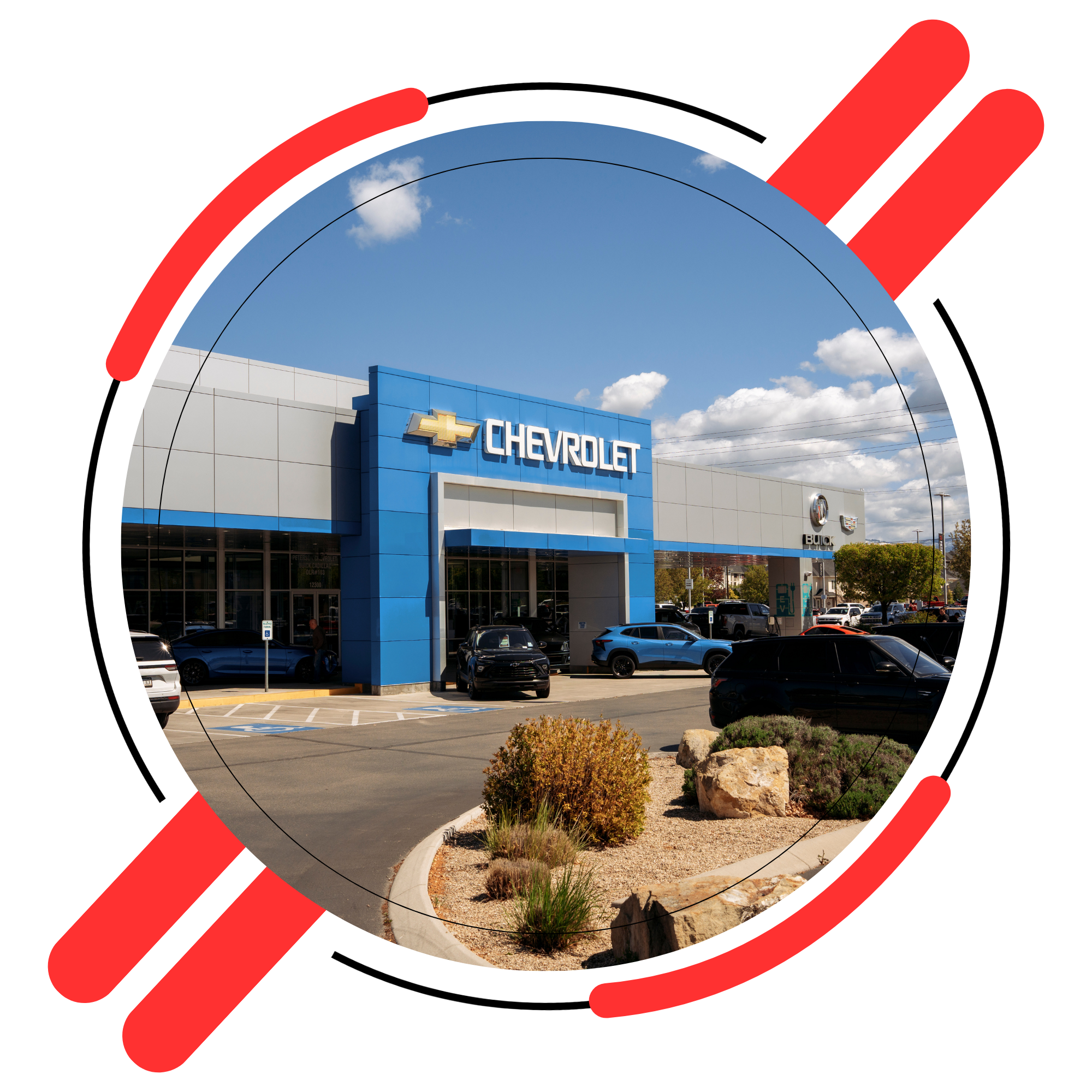 Sunny day view of a modern car dealership showroom with new vehicles parked out front.
